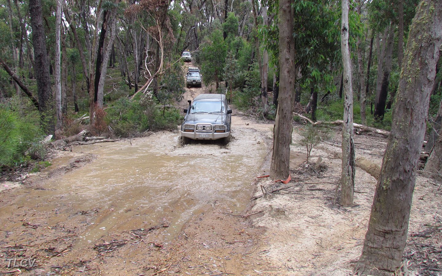 21-Iceman drives through a very muddy bog on the McGuire Track.JPG